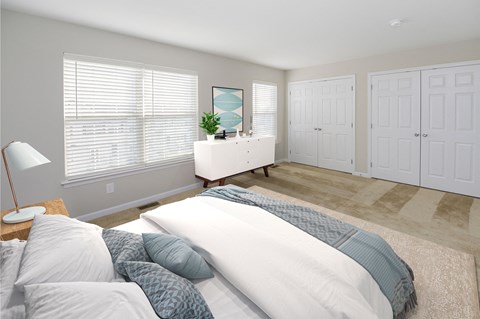 a bedroom with a bed and a dresser in it