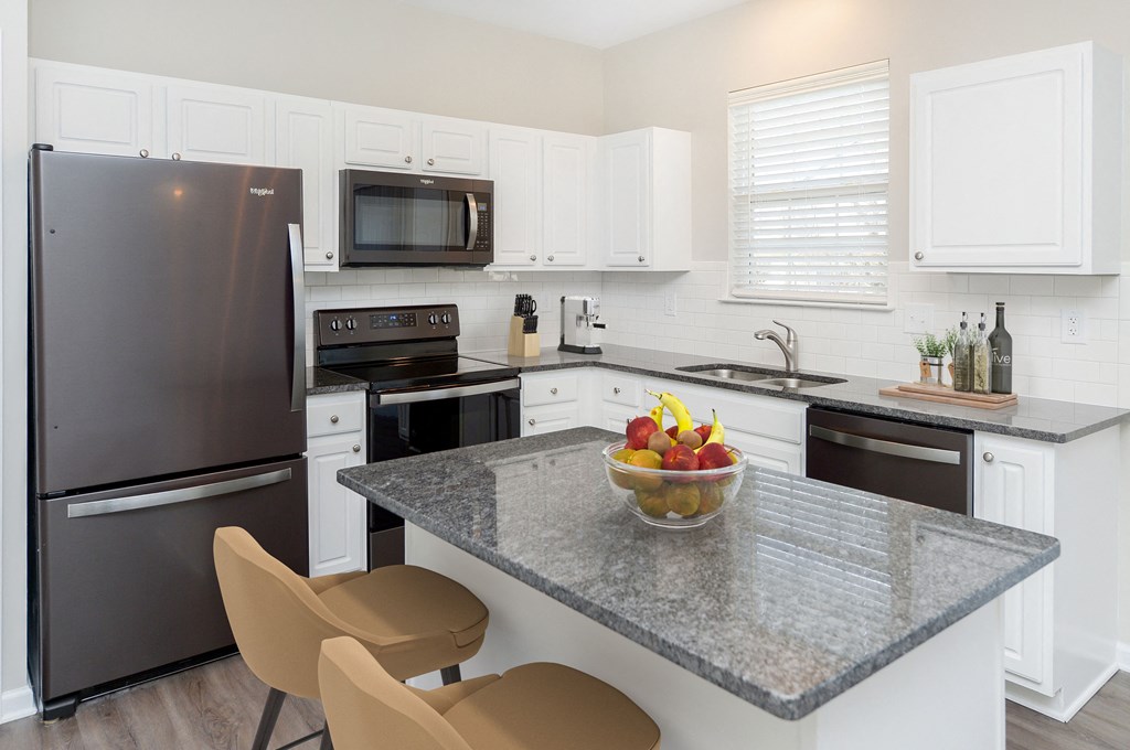 a kitchen with stainless steel appliances and a granite counter top