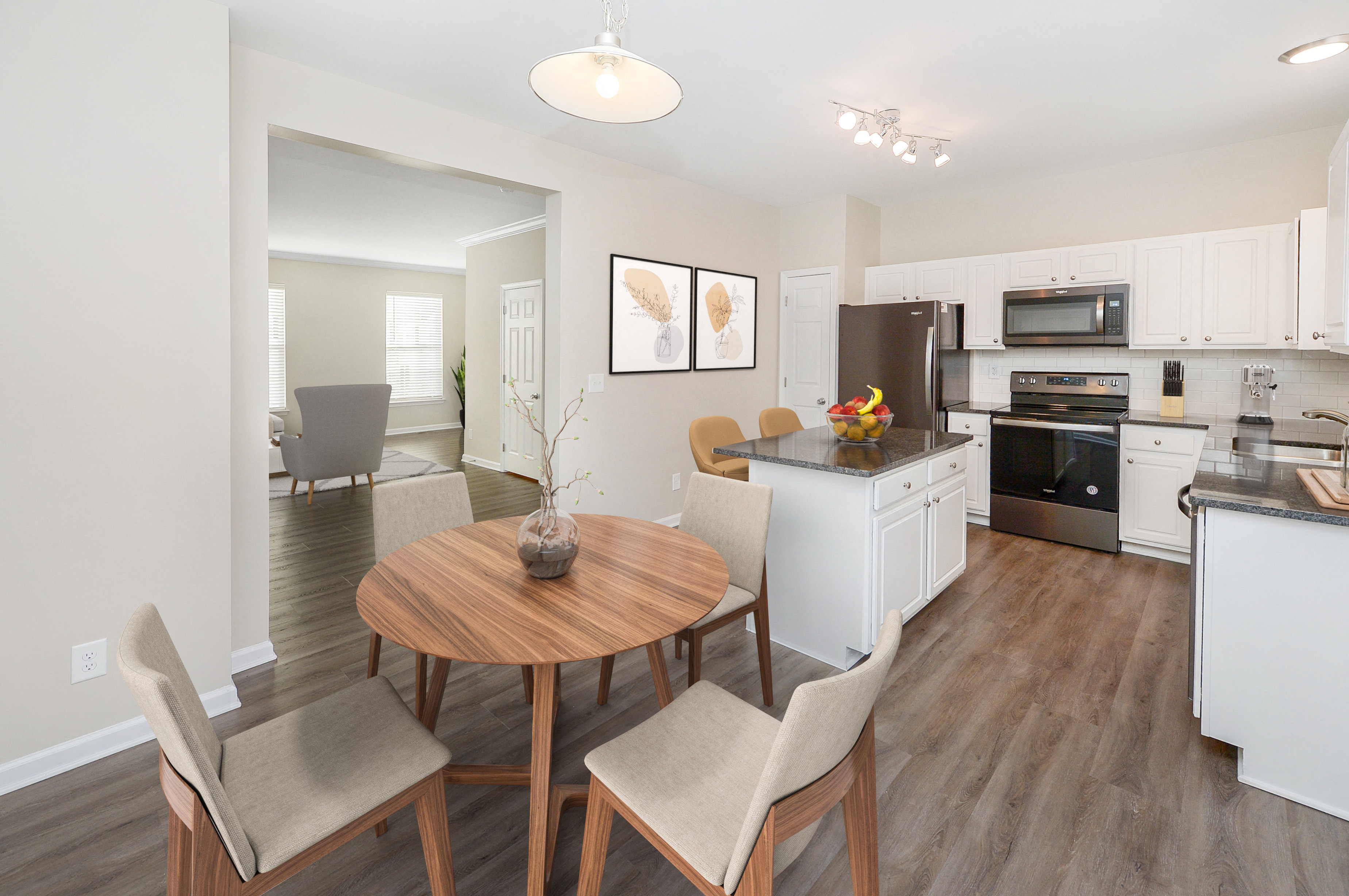a kitchen and dining room with a wooden table and chairs