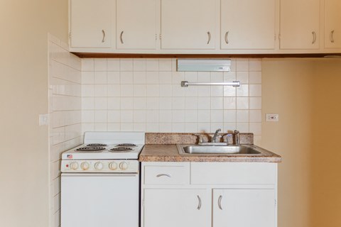 an old kitchen with white appliances and white cabinets
