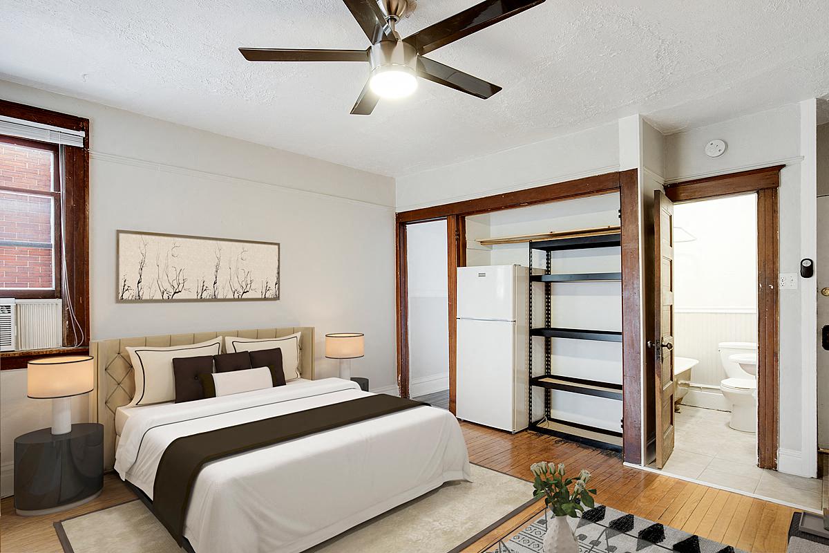 a bedroom with a bed and a ceiling fan