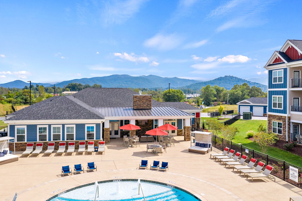 aerial view of property with swimming pool and mountain views
