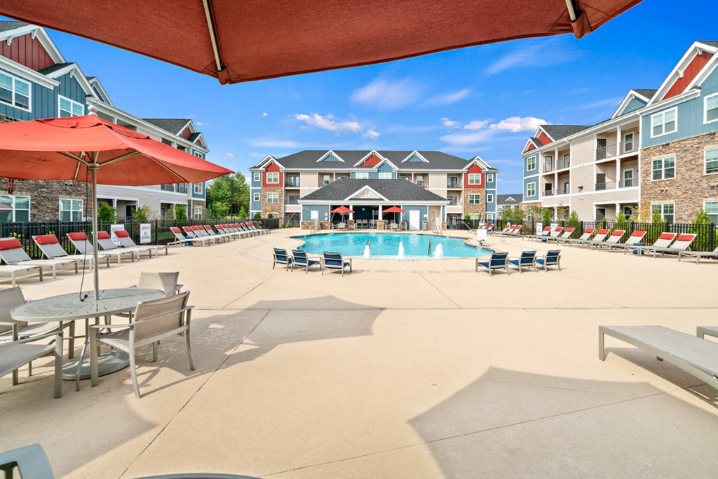 our apartments have a large pool with chairs and umbrellas