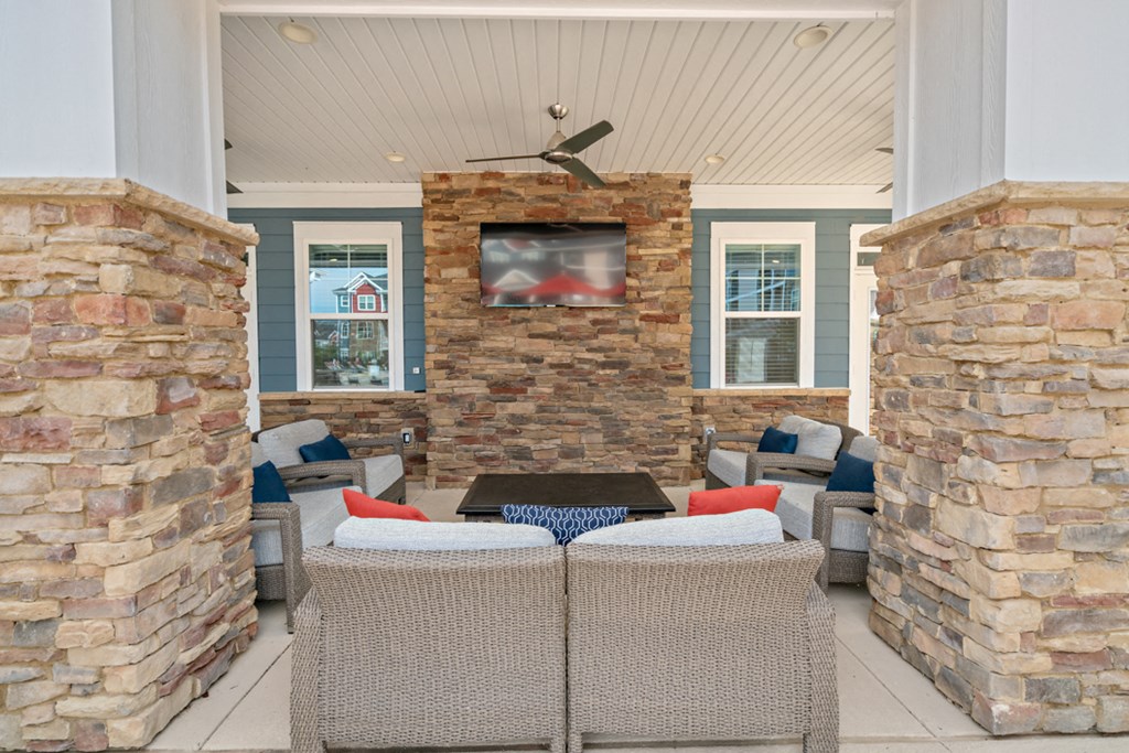 the screened porch has a table with chairs and a tv