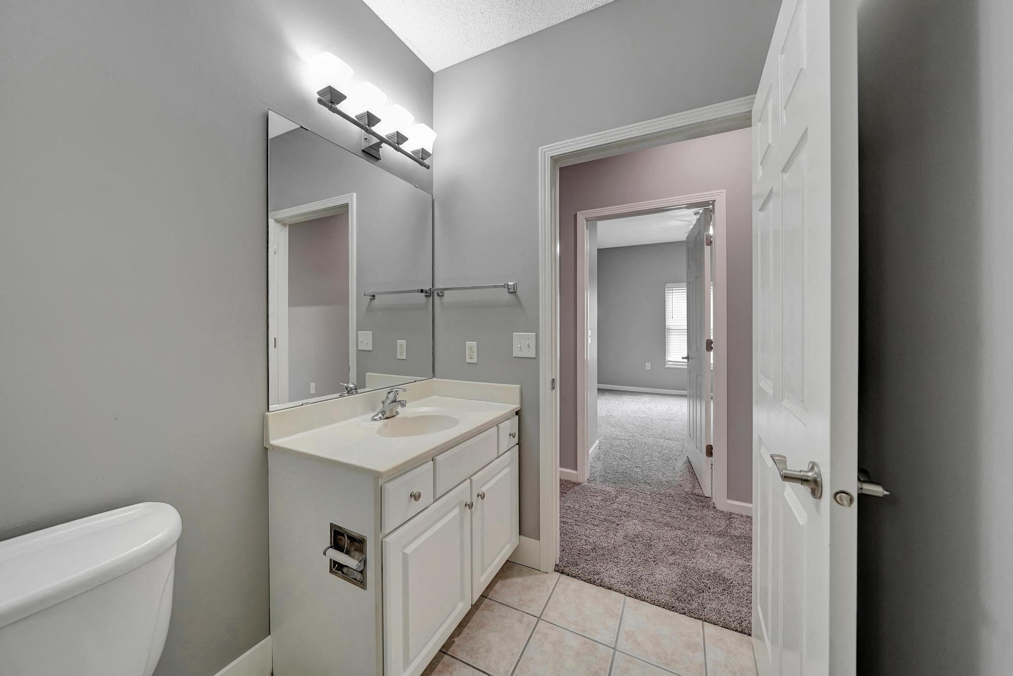 a bathroom with a sink and a toilet and a mirror