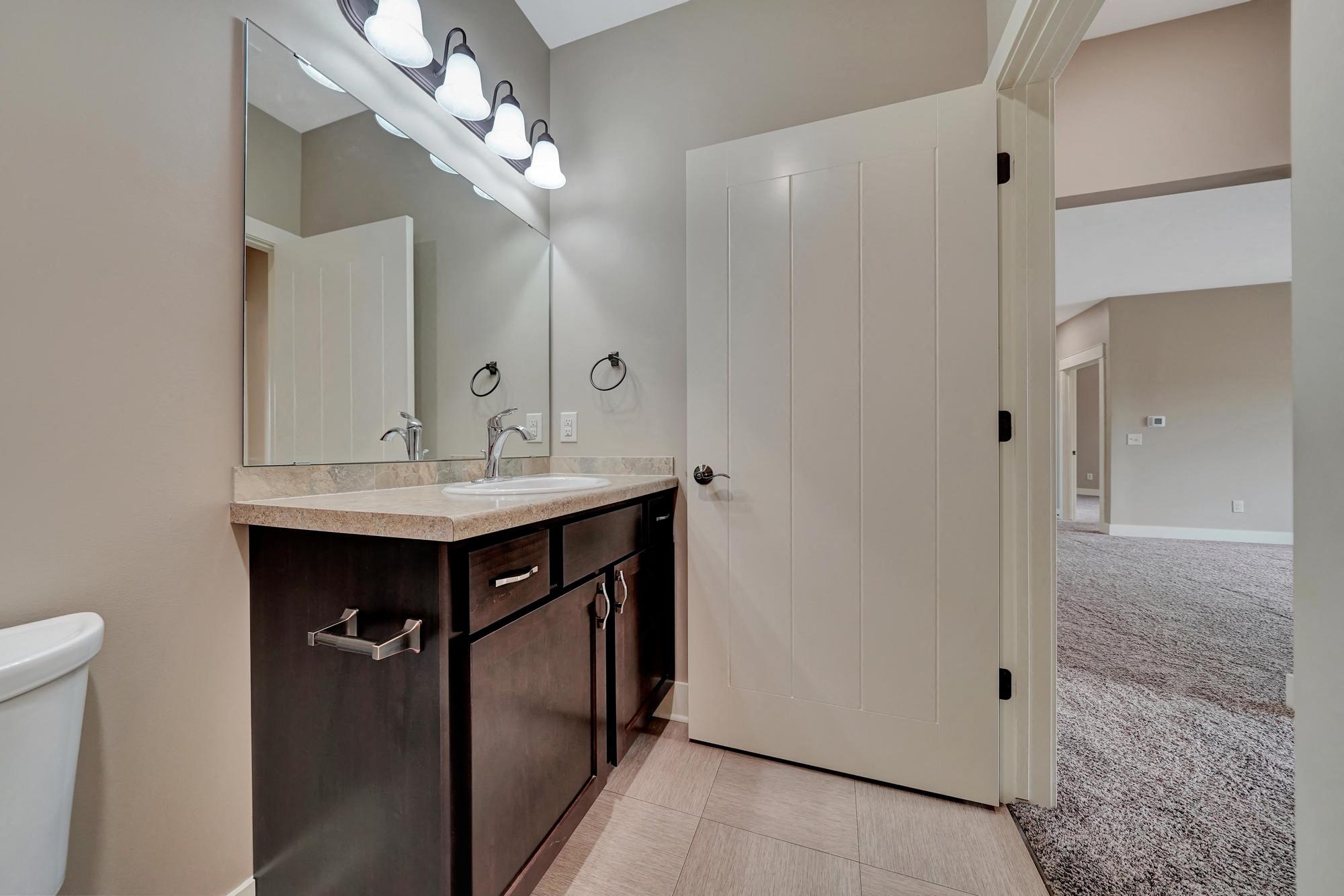 a bathroom with a sink and a toilet and a mirror