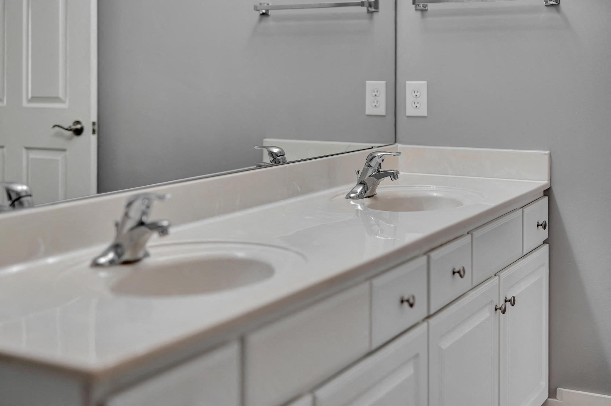 a bathroom with two sinks and a mirror