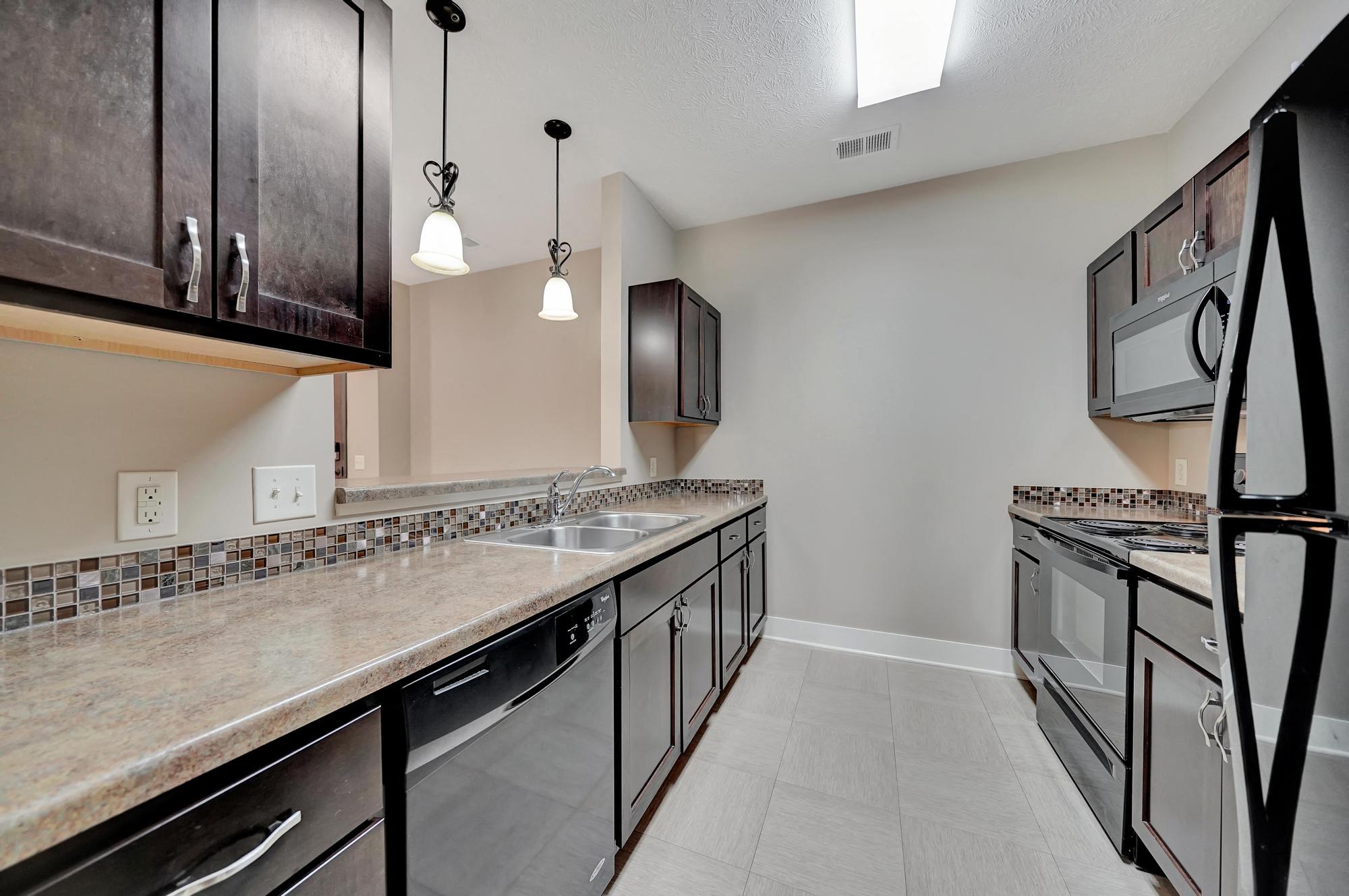 an empty kitchen with stainless steel appliances and counter tops