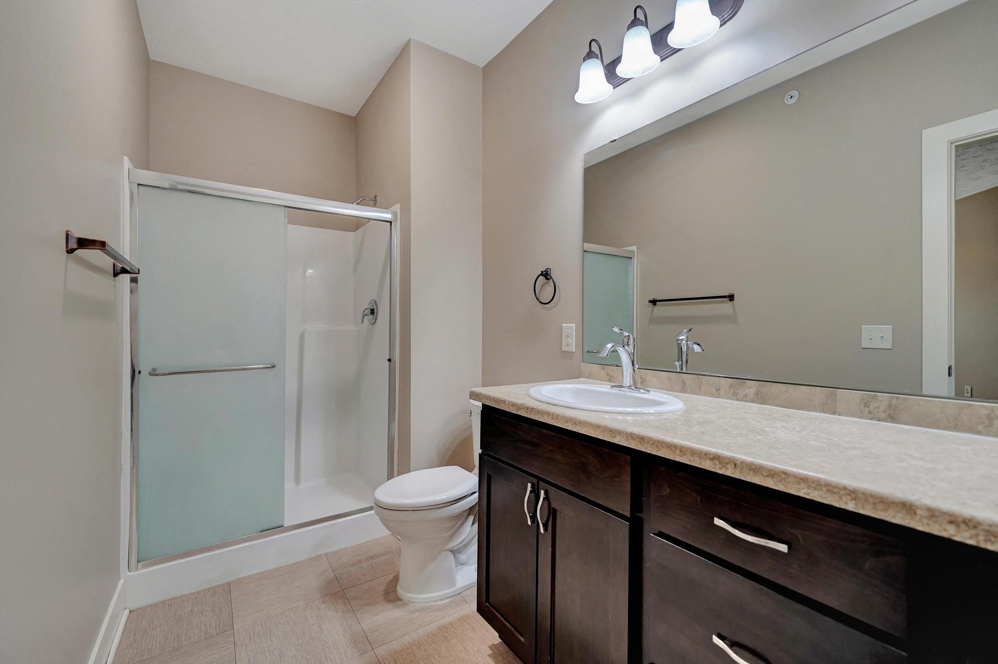 a bathroom with a sink toilet and a shower