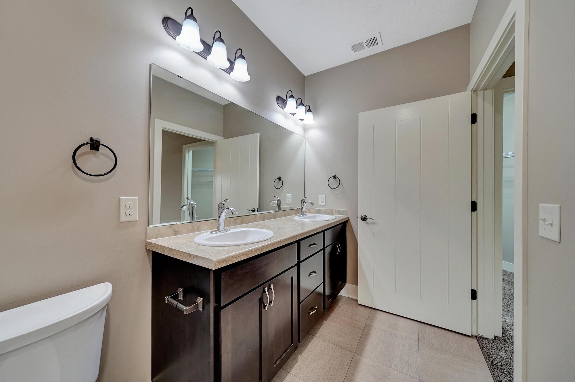 a bathroom with a sink and a toilet and a mirror