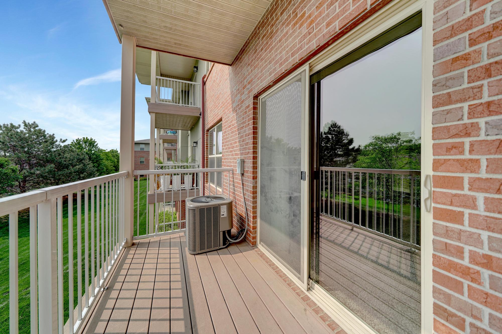a balcony with a heater on the side of a building