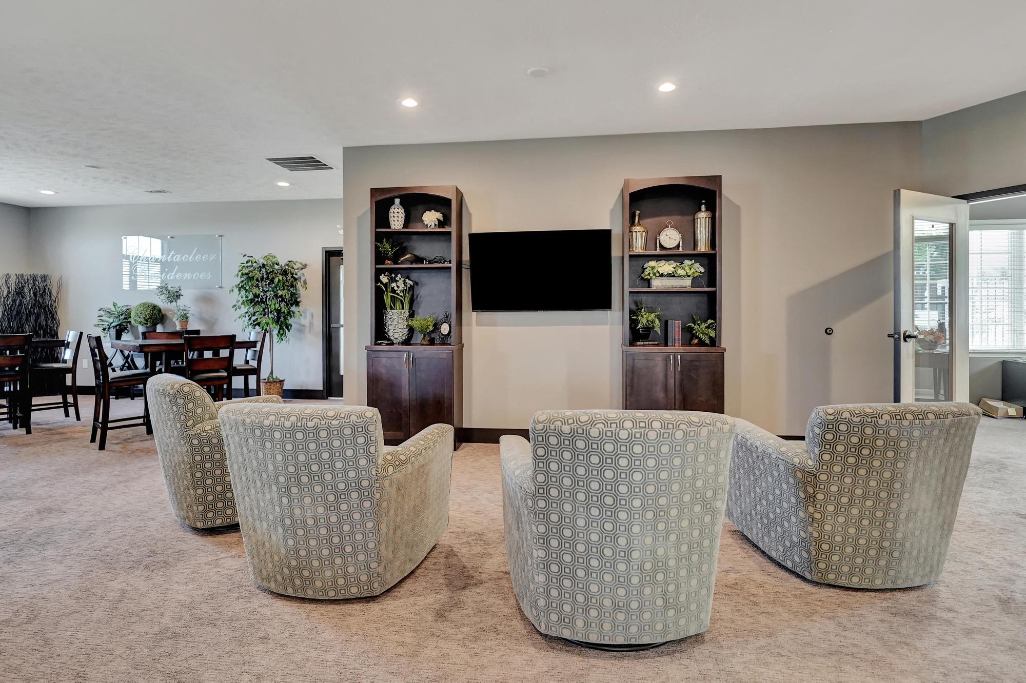 a living room with a table and chairs and a television