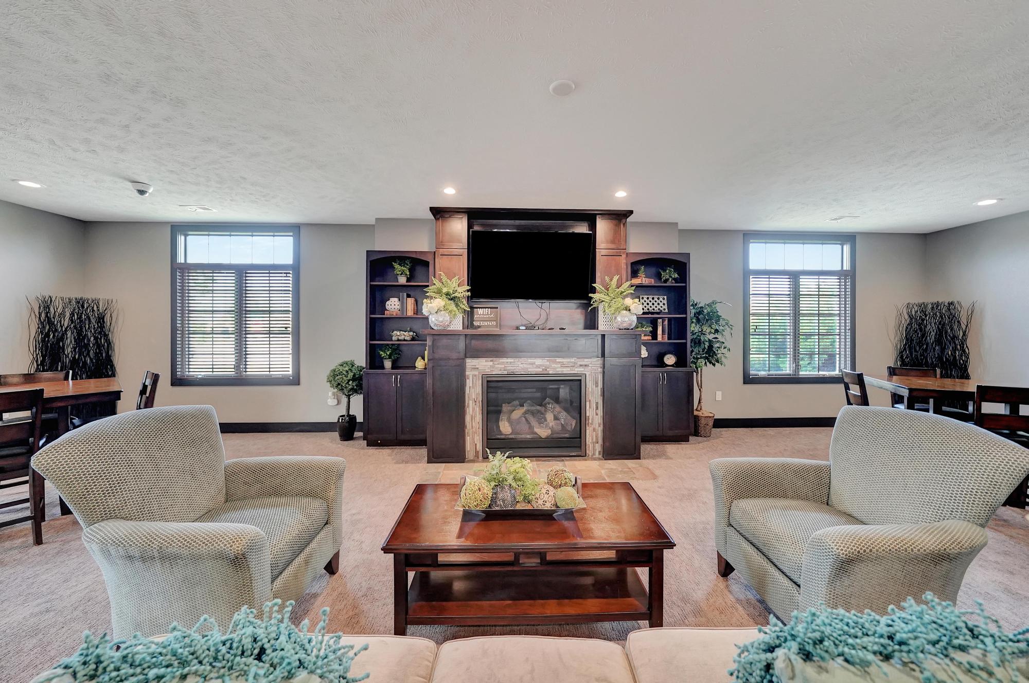 a living room with couches and chairs and a fireplace