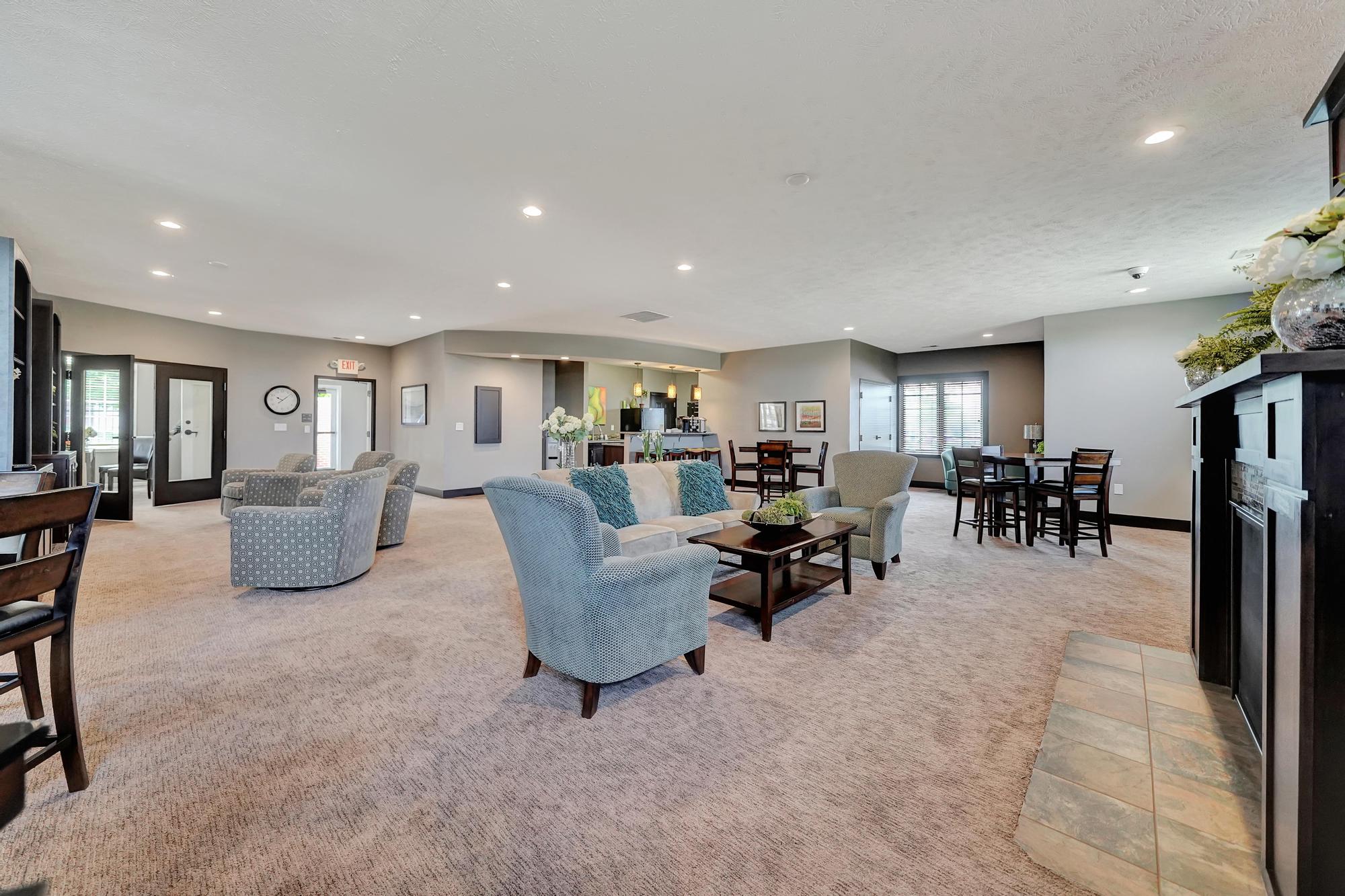 a living room with couches and chairs and a dining room table
