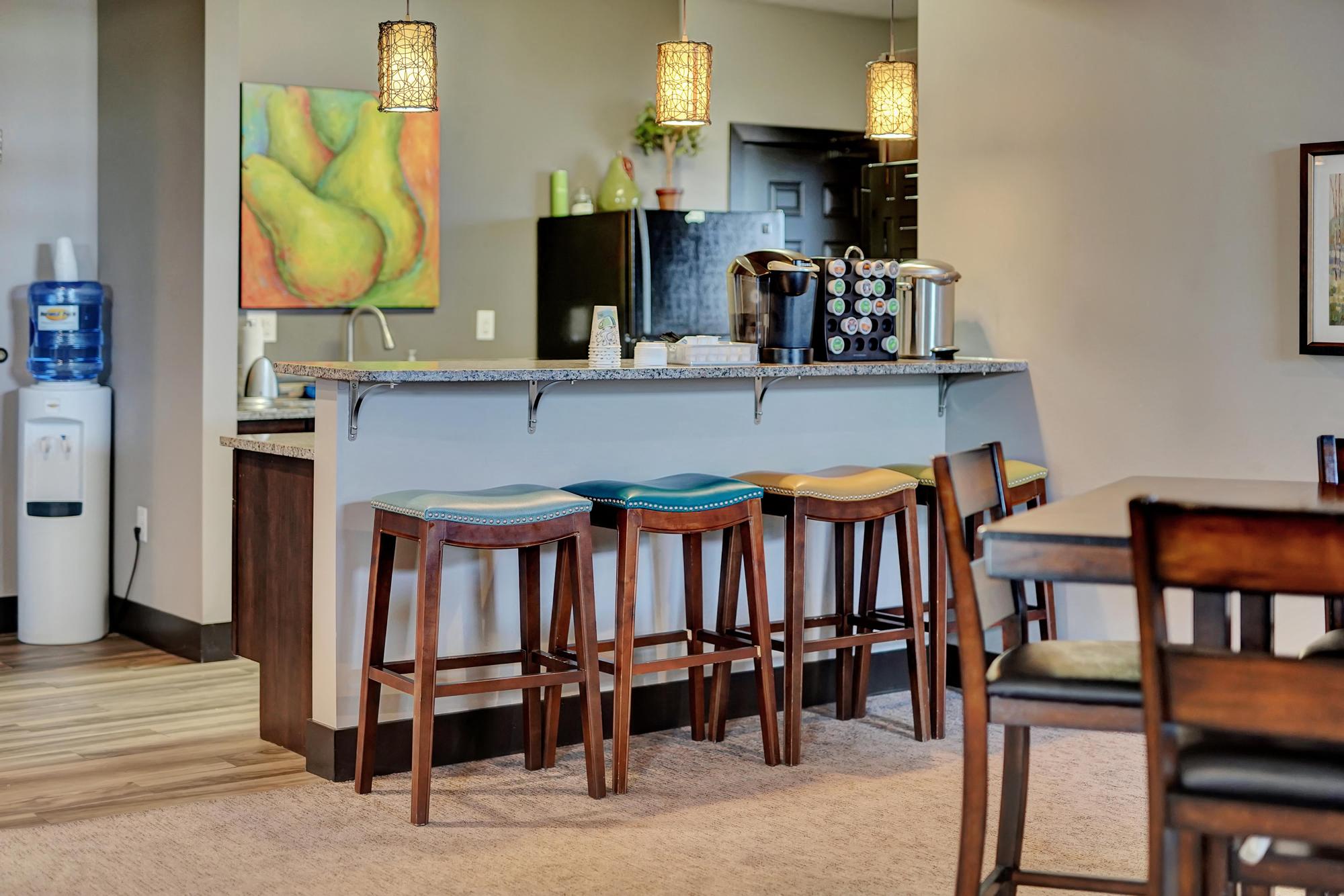 a kitchen and dining area with bar stools