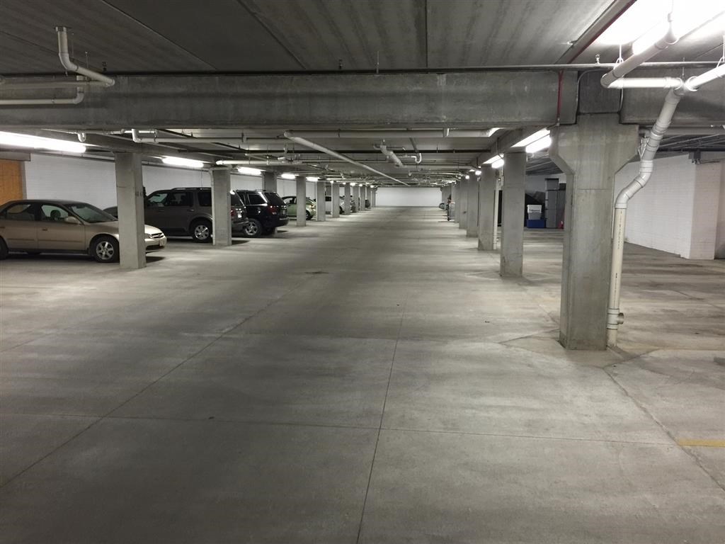 an empty parking garage with cars parked in it