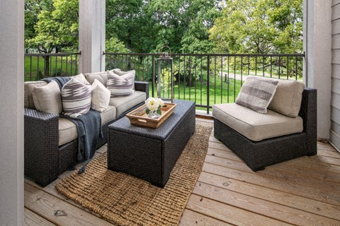 A patio with two couches and a coffee table.