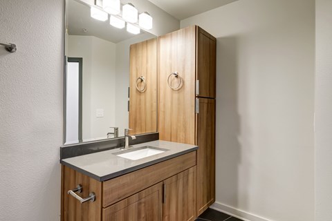 A bathroom with a sink and a mirror.