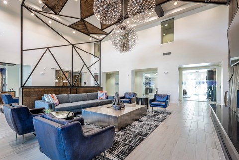 a living room with couches and chairs and a table