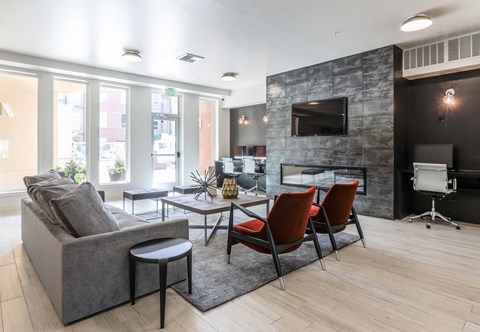 a living room with a couch and chairs and a tv