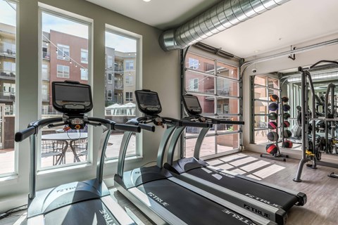 the gym at the district flats apartments in lenexa