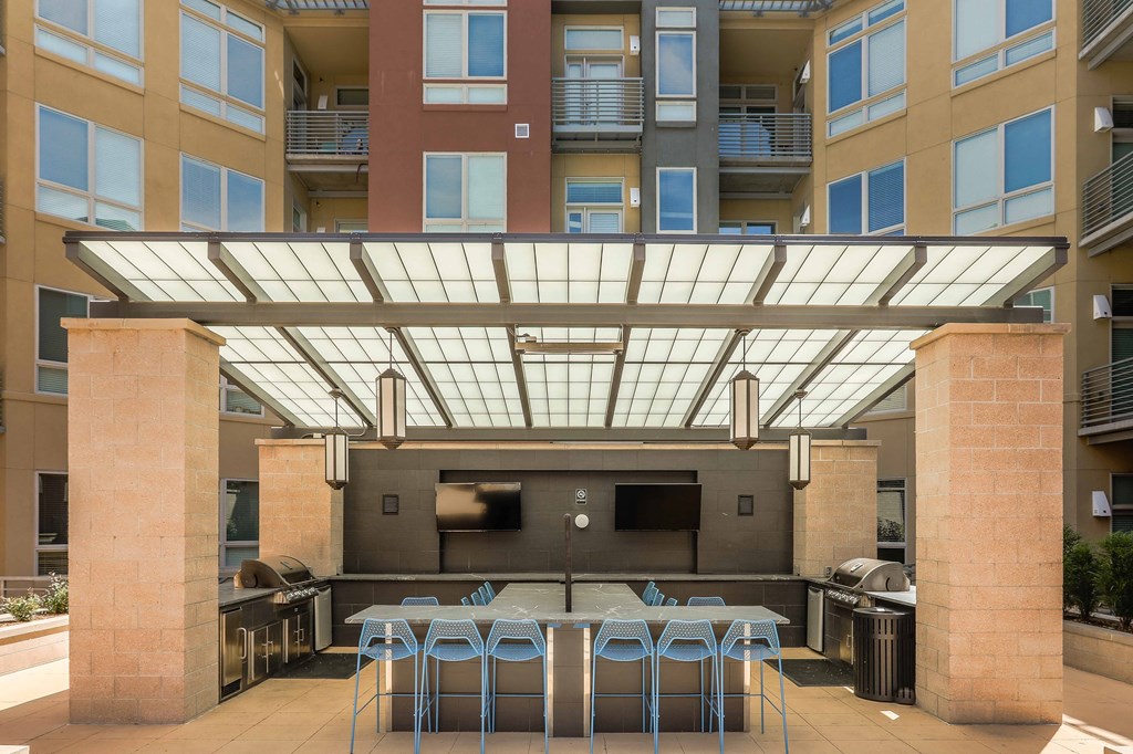 a communal area with tables and chairs under a glass roof