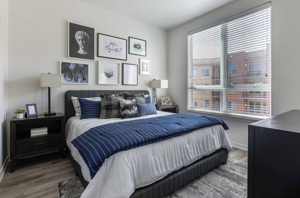 a bedroom with a bed and a large window