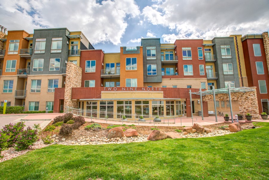 a large building with a green lawn and grass in front of it