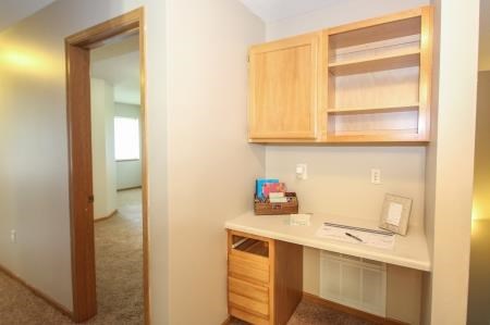 a small kitchen with a desk and a mirror