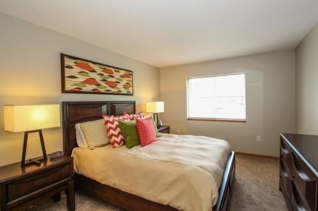 a bedroom with a large bed and a window