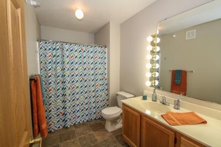 a bathroom with a shower and a sink and a toilet