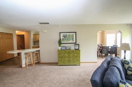 a living room with a couch and a kitchen and