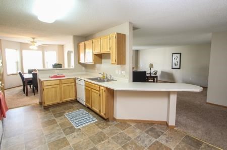 a kitchen and a living room with a sink