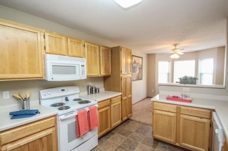 a large kitchen with a stove and a microwave