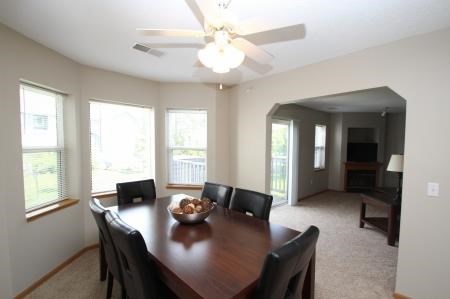 a dining room with a table and chairs and a ceiling fan