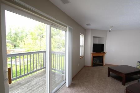 a living room with a sliding glass door and a balcony