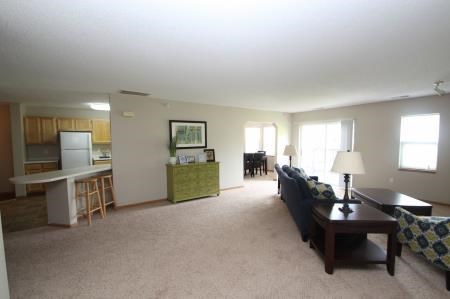 a living room and kitchen with a couch and a table