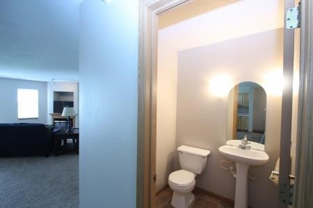 a bathroom with a toilet and a sink and a mirror