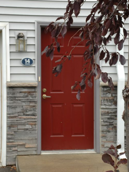 a red door on the side of a house