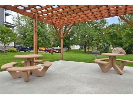 a patio with a picnic table and a pergola