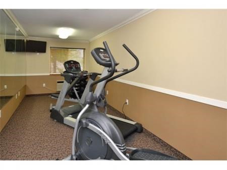a gym with a exercise bike in a room