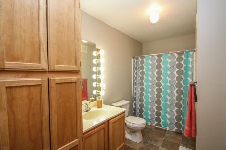 a bathroom with a toilet and a sink and a shower