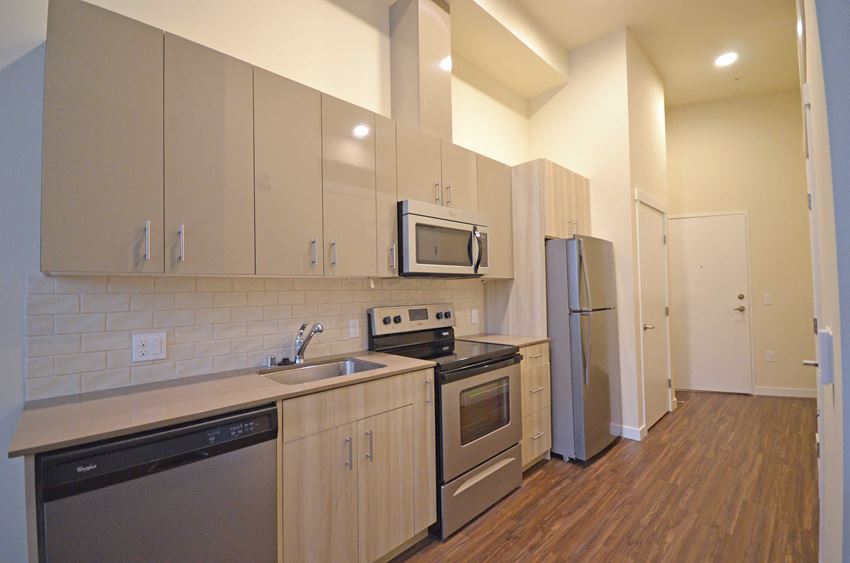 a kitchen with stainless steel appliances and white cabinets