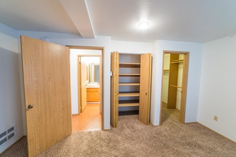 an empty room with a closet and a staircase in a house