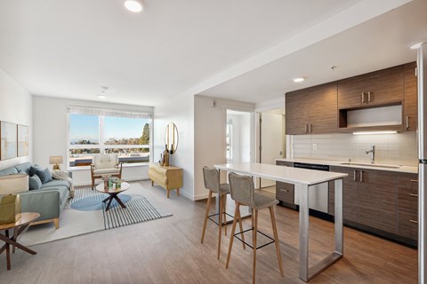 A modern kitchen with a dining table and chairs.
