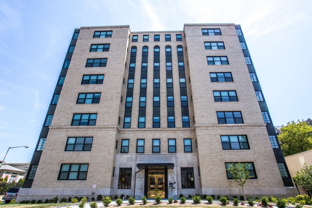 a tall brick building with the front entrance of it