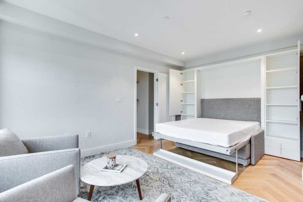 Furnished studio at the Century with murphy bed and extra bedside storage