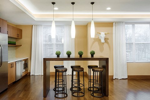 a kitchen with a table and stools