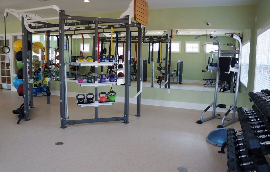 a gym with weights and other equipment in it