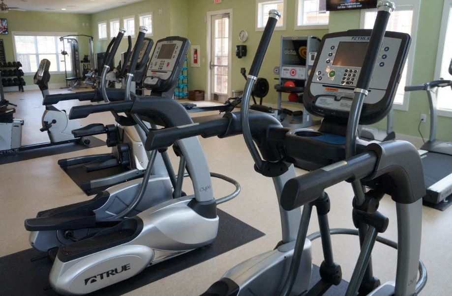 a row of exercise bikes in a gym